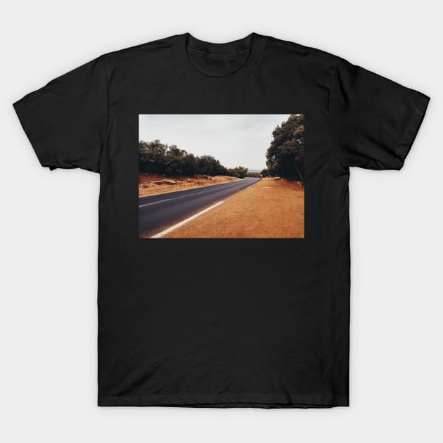 Man Walking Along Empty Road T-Shirt by visualspectrum